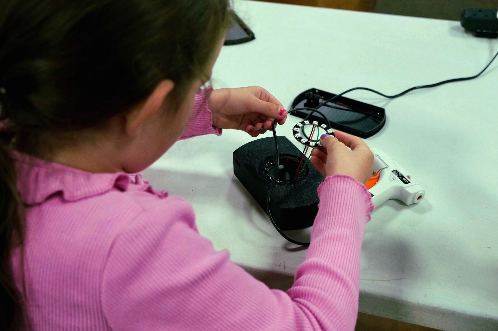 Child assembling her Easter Glow project